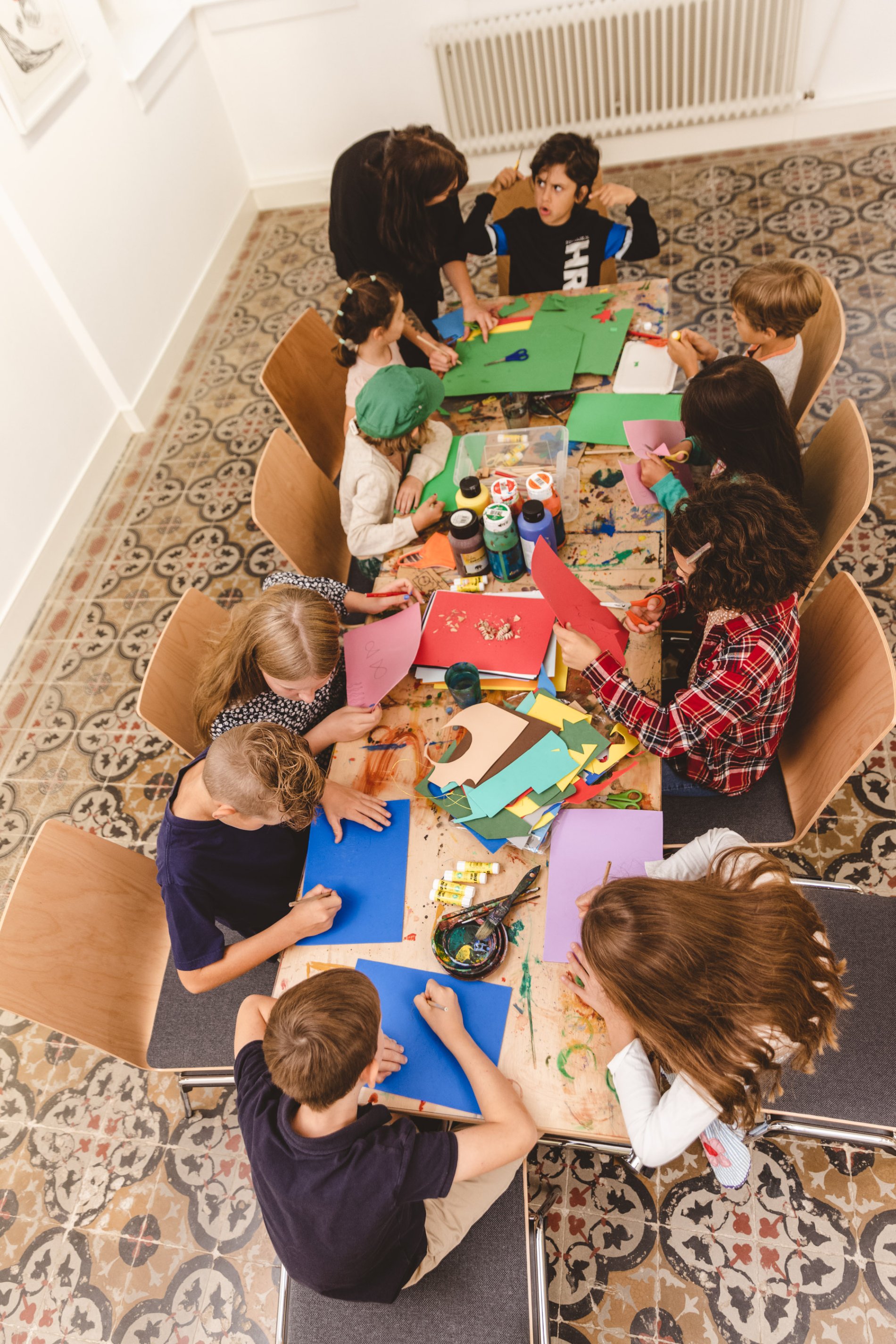 Am Tisch gemeinsam werkeln in der KinderKunstWerkstatt